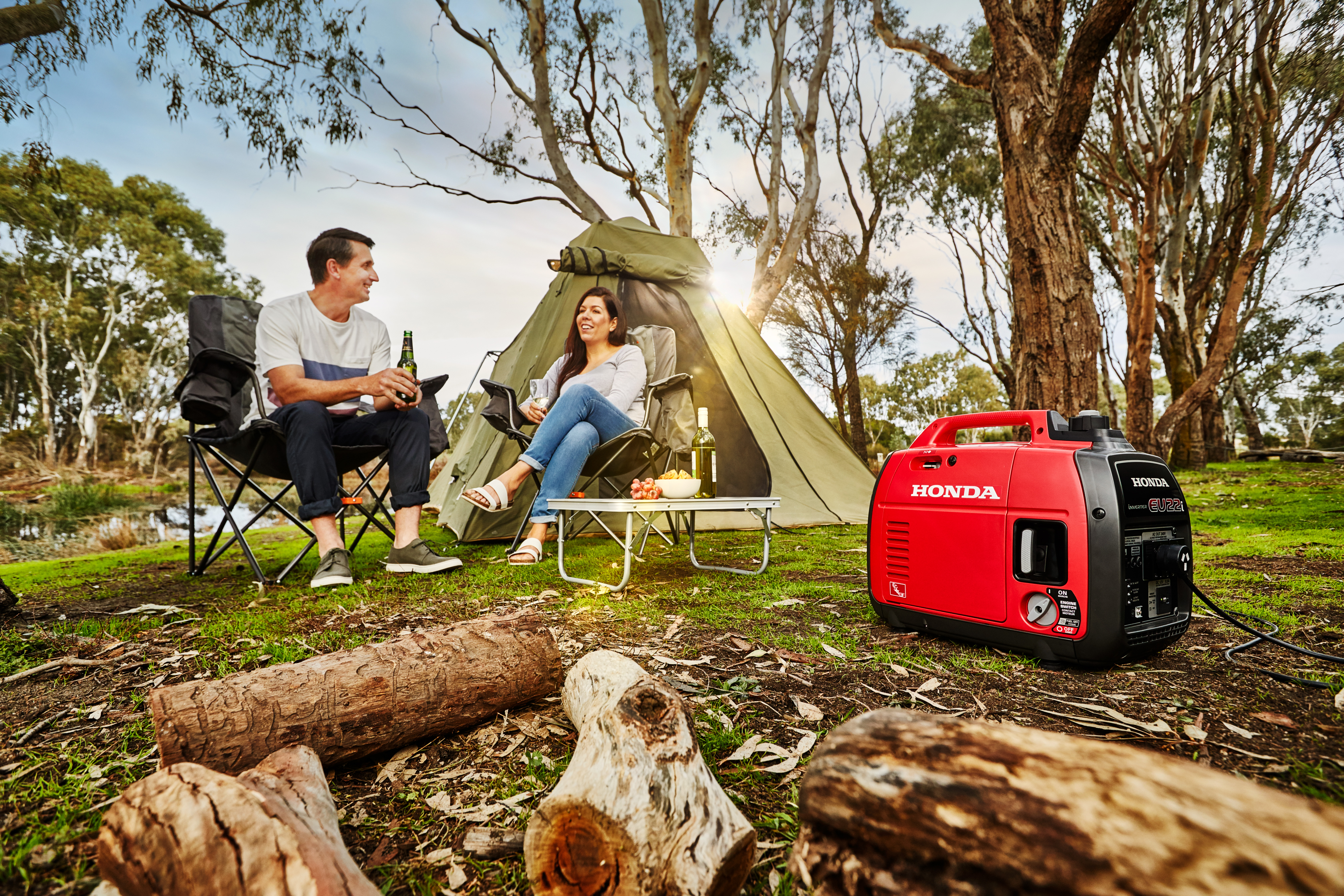 A couple using an inverter generator in the outdoors